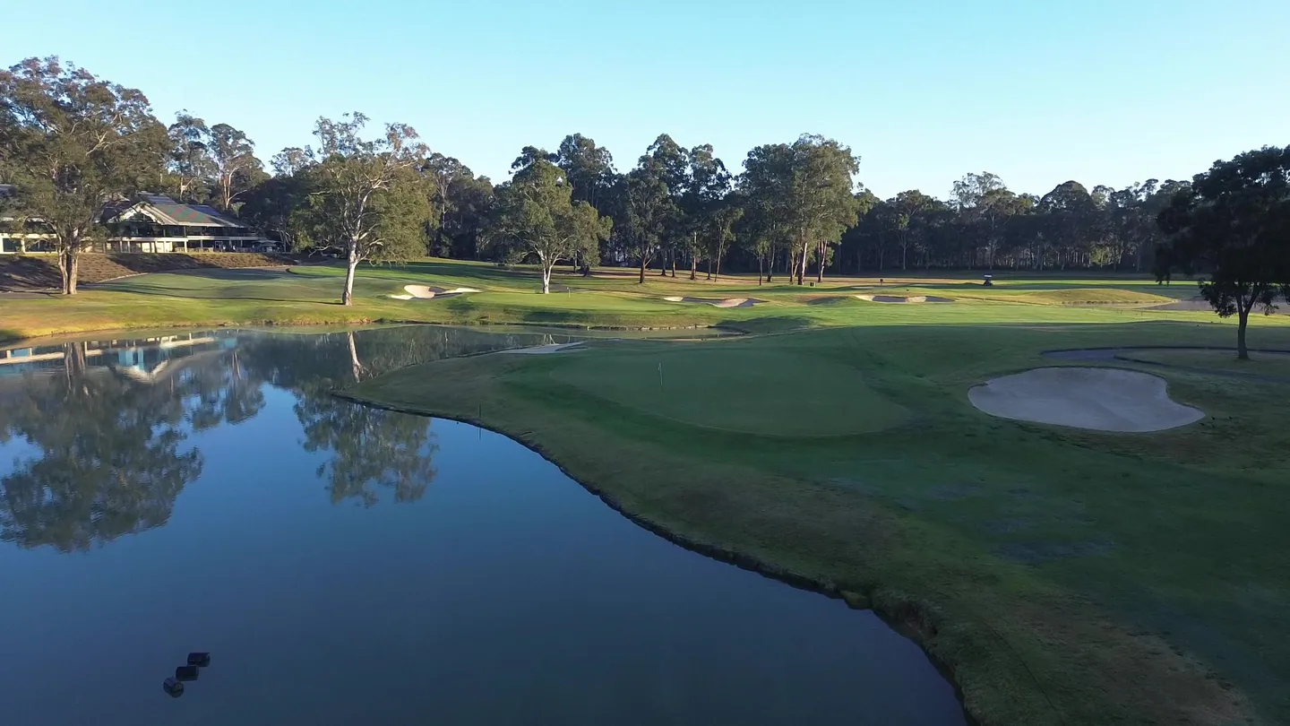 Riverside Oaks Golf Resort lake and green at sunrise