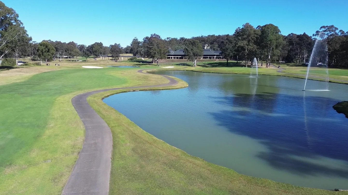 Fountain lake and cart path at Riverside Oaks Golf Resort