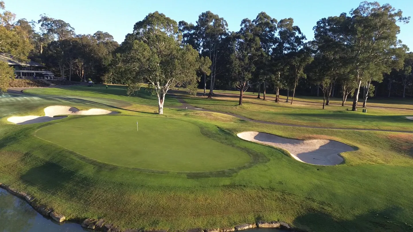 Riverside Oaks Gangurru course green framed by bunkers